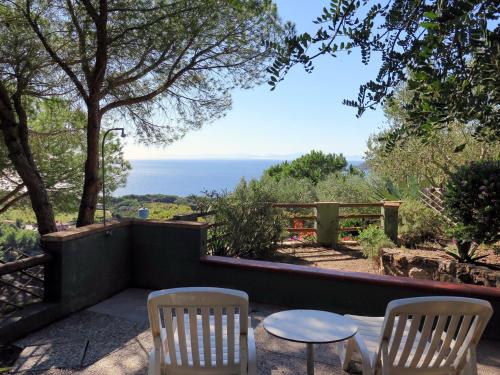 a patio with two chairs and a table at Holiday Home Piccola Oasi-6 by Interhome in Capoliveri