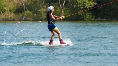 a woman on a surfboard in the water at Parco Del Sangro in Castel di Sangro