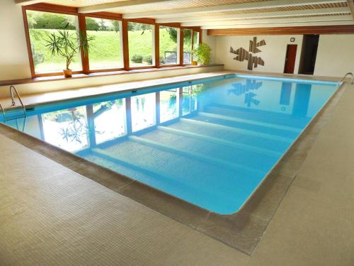 a large swimming pool in a house at Apartment Grand Hôtel A18 by Interhome in Villars-sur-Ollon