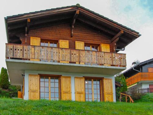 a house with a balcony on top of a hill at Chalet Chalet Enfin by Interhome in Nendaz