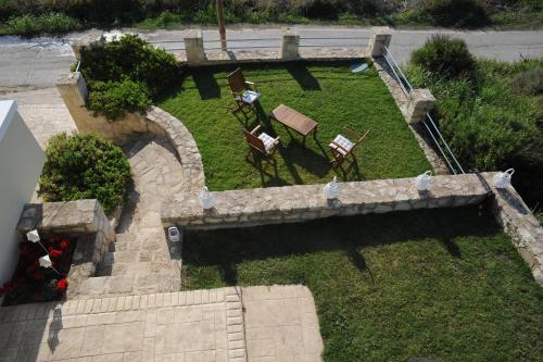 an overhead view of a garden with two chairs and a bench at Villa Nimertis in Xirokámbion