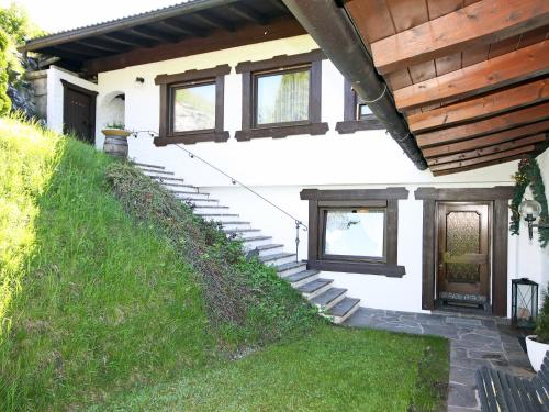 a house with stairs leading up to the front door at Apartment Lener-2 by Interhome in Matrei am Brenner