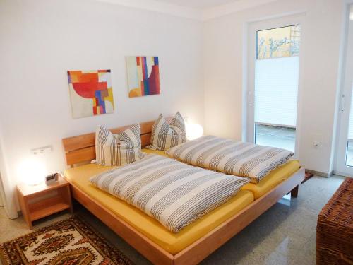 een slaapkamer met een bed met 2 kussens erop bij Apartment Willmann by Interhome in Eisenbach