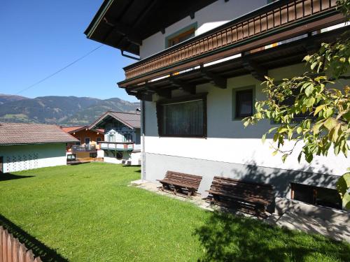 a bench in a yard next to a house at Holiday Home Chalet Alpin by Interhome in Kaprun