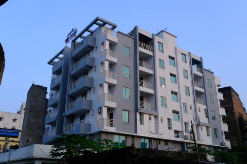 a building with balconies on the side of it at Hotel Girija Sunrise in Deoghar