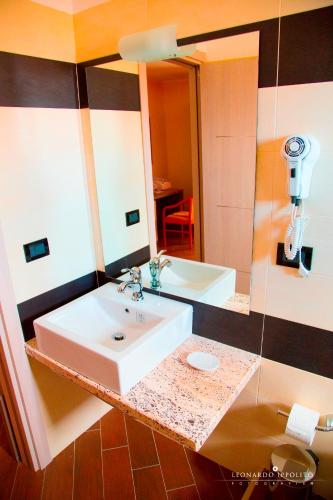 a bathroom with a sink and a large mirror at San Pio Bed & Breakfast in Cariati