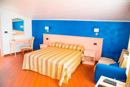 a bedroom with a bed and a blue wall at San Pio Bed & Breakfast in Cariati