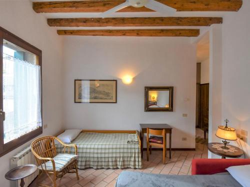 a living room with a bed and a table at Apartment Barbaria de le Tole by Interhome in Venice