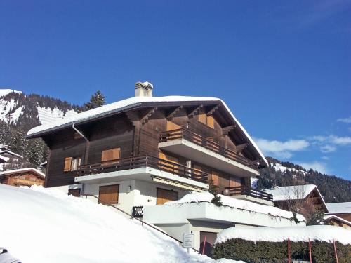 a large building with snow on top of it at Apartment Roche-Neige by Interhome in Anzère