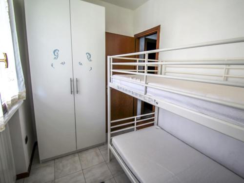 a room with two bunk beds and a closet at Apartment Blue Lagoon by Interhome in  Monvalle 