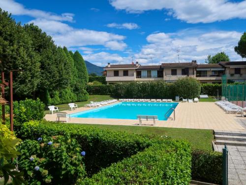 a villa with a swimming pool in a garden at Apartment Blue Lagoon by Interhome in  Monvalle 