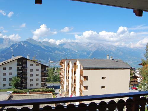 a view from a balcony of buildings and mountains at Apartment Ambassador I Apt 7 by Interhome in Nendaz