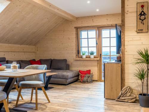 a living room with a couch and a table at Apartment Schmalzenhof by Interhome in Hofstetten