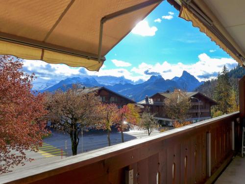a balcony with a view of the mountains at Apartment Arlette Nr- 34 by Interhome in Gstaad