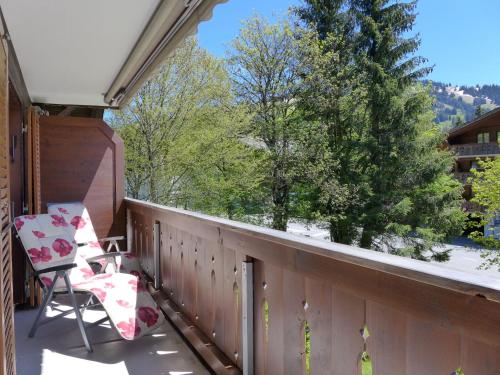 a balcony with two chairs and a tree at Apartment Arlette Nr- 34 by Interhome in Gstaad