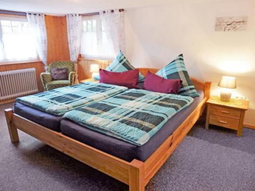 a bedroom with a large wooden bed in a room at Holiday Home Haus Schwärzel by Interhome in Neuried