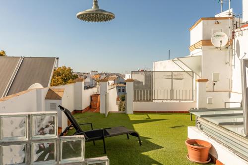 a balcony with a green lawn on a building at Hércules XCI Apartments in Seville