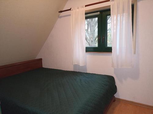 Кровать или кровати в номере Czarodziejski Domek