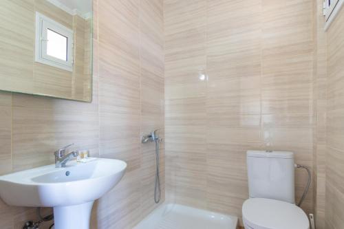 a bathroom with a toilet and a sink at Myrodato Rooms in Xanthi