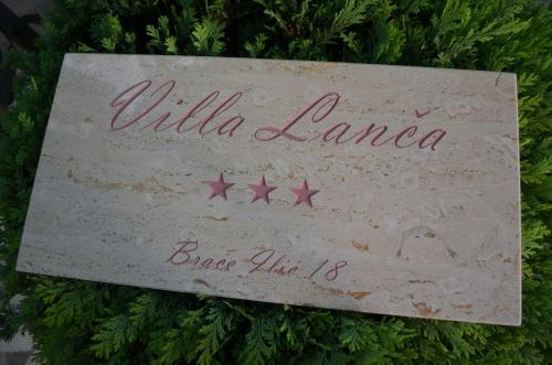 a sign that says willilla lanca on a christmas tree at Villa Lanca in Fažana