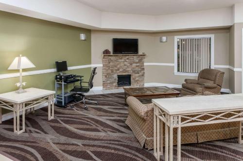 a living room with furniture and a fireplace at Super 8 by Wyndham Rochester in Rochester