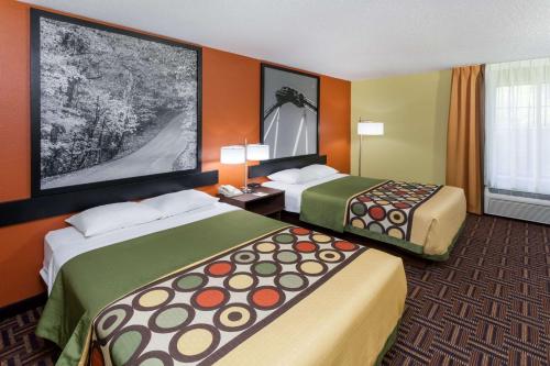 a hotel room with two beds and a window at Super 8 by Wyndham Rochester in Rochester