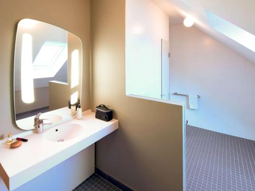 a bathroom with a sink and a mirror at ibis Brest Kergaradec in Brest