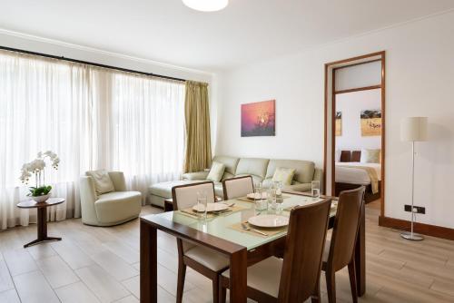 a living room with a dining table and a living room at Executive Residency by Best Western Nairobi in Nairobi