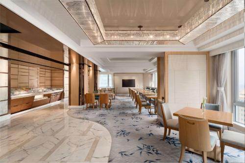 a large dining room with tables and chairs at Kerry Hotel, Beijing by Shangri-La - 5 Kilometers to The Forbidden City in Beijing
