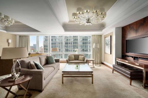 a living room with a couch and a television at Kerry Hotel, Beijing by Shangri-La - 5 Kilometers to The Forbidden City in Beijing