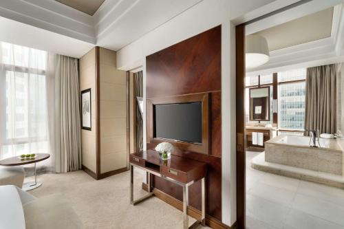 a hotel room with a television and a tub at Kerry Hotel, Beijing by Shangri-La - 5 Kilometers to The Forbidden City in Beijing