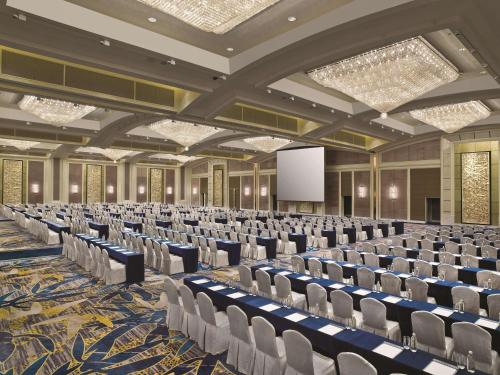 a large room with rows of chairs and a screen at Kerry Hotel, Beijing by Shangri-La - 5 Kilometers to The Forbidden City in Beijing