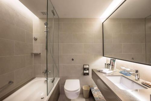 a bathroom with a sink, toilet and bathtub at JEN Penang Georgetown by Shangri-La in George Town