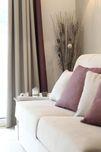 a bedroom with two beds with white and purple pillows at Residhotel Résidence Pont du Gard in Remoulins
