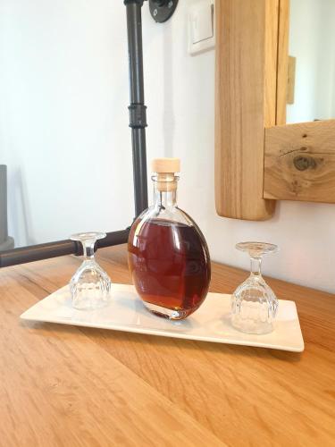 a bottle and two glasses sitting on a cutting board at Sifnos Hotel Benaki in Platis Yialos Sifnos