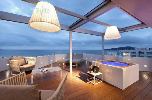 a living room with a view of the ocean at Hotel Garbi Ibiza & Spa in Playa d'en Bossa