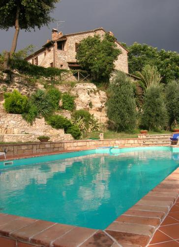 a large swimming pool in front of a house at Agriturismo Podere Luchiano in Amelia