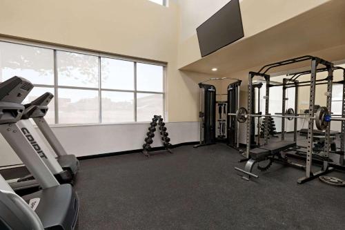 a gym with tread machines and a large window at Wingate by Wyndham Lethbridge in Lethbridge