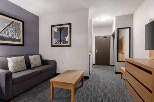 a living room with a couch and a table at Wingate by Wyndham Lethbridge in Lethbridge