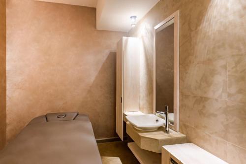 a small bathroom with a sink and a toilet at Radisson Blu Resort Saidia Beach in Saidia 