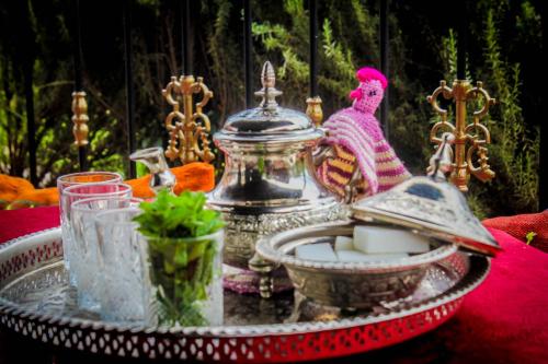 a glass table with a tray of food on it at Les Jardins Yasmina Bin el-Ouidane in Bine el Ouidane