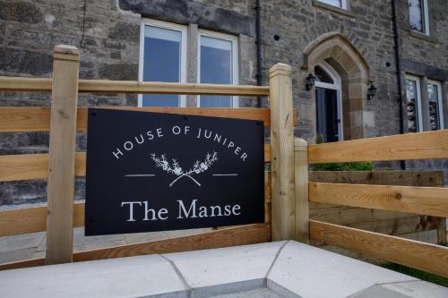 a sign for a house ofluencer the manise at House of Juniper in Broadford