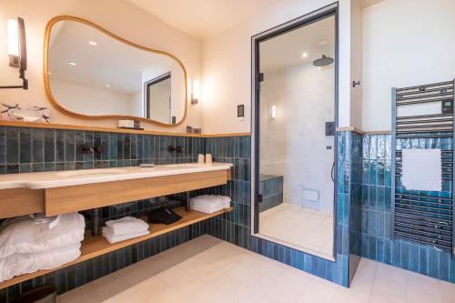 a bathroom with a sink and a shower at H&ocirc;tel Le Caf&eacute; de Paris in Biarritz