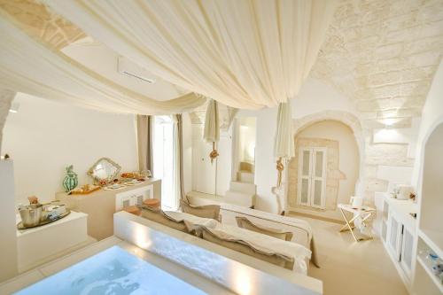 a large room with a swimming pool in the middle at Eurydice Suite with Infinity Jacuzzi in Ostuni