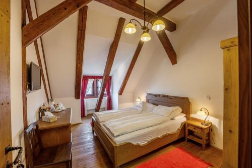 a bedroom with a large bed in a room with wooden beams at Casa Kroner in Sighişoara