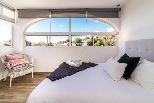 a bedroom with a large bed and a window at VB Seguiriyas Paired House 2BDR Sea Views in Benalmádena