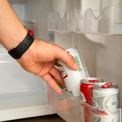 a person holding a carton of milk in a refrigerator at Larison Executive by Easy Hotéis in Porto Velho