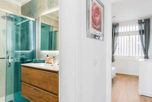 a bathroom with a sink and a mirror at Las Vistas Cristianos by Welcome Tenerife in Los Cristianos