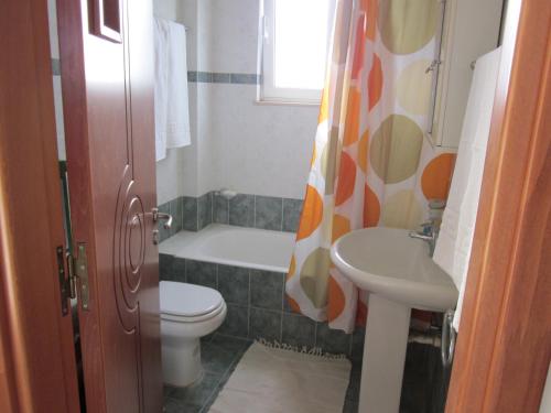 a bathroom with a toilet and a sink at Sunshine Villa in Gennadi