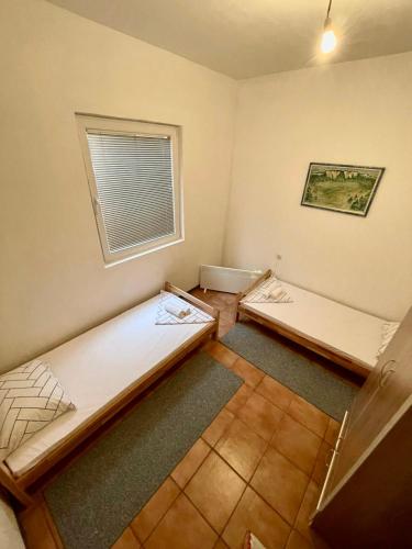 a room with two beds in it with a window at Apartman Start in Pale